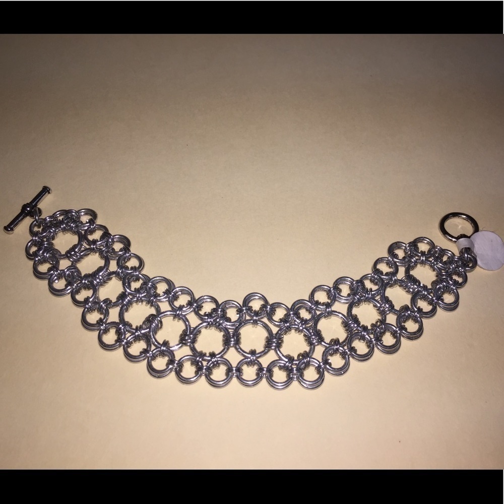 One of a kind. Hand woven aluminum bracelet
